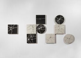 three white and two black floor plates with gunshot marks
